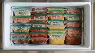 Open chest freezer filled with neatly labeled bags of frozen meals