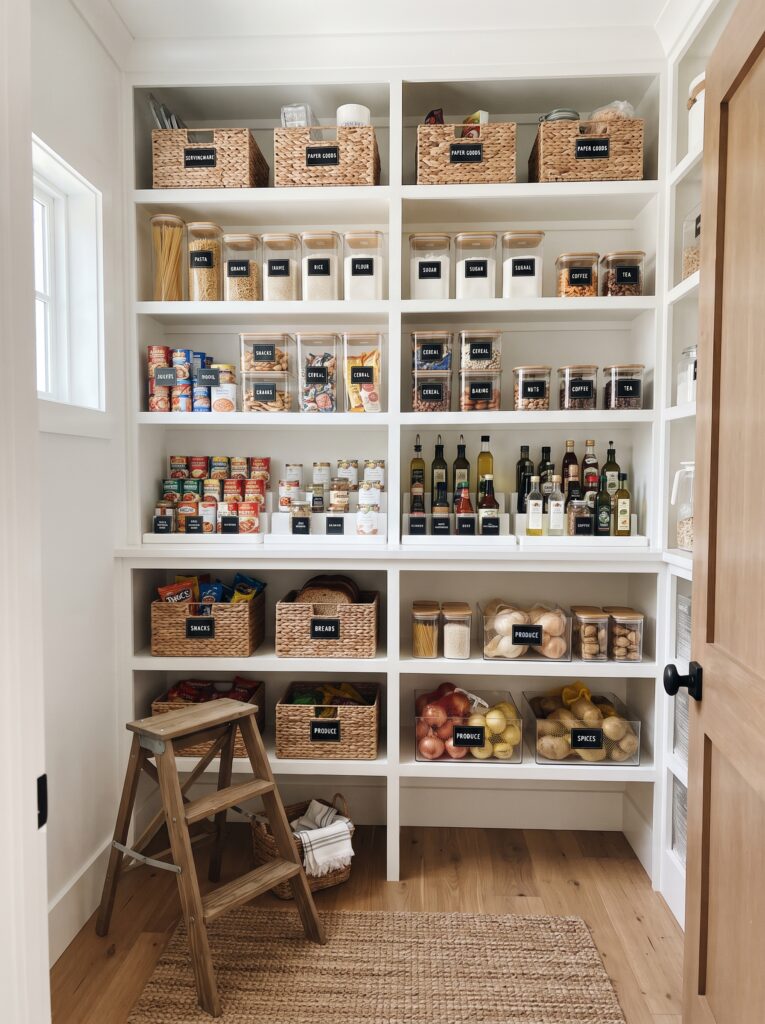Finished, fully organized pantry with labeled containers and clear zones